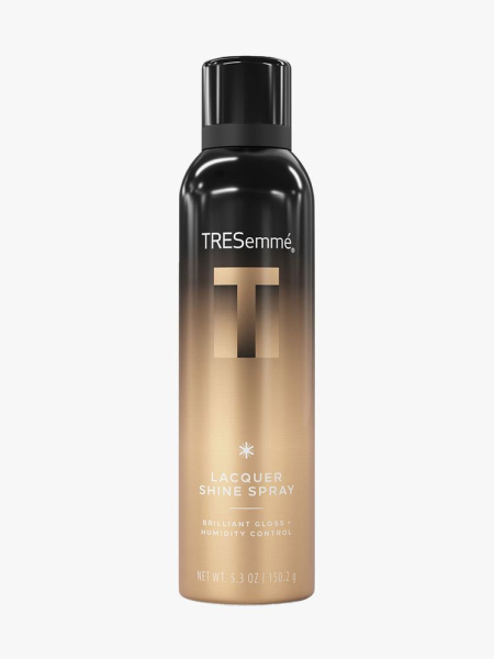 Black and gold spray bottle of TRESemme A-List Collection Dry Texturizing Spray with black cap on light gray background