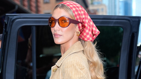 Bella Hadid wearing a gingham head scarf and sunglasses